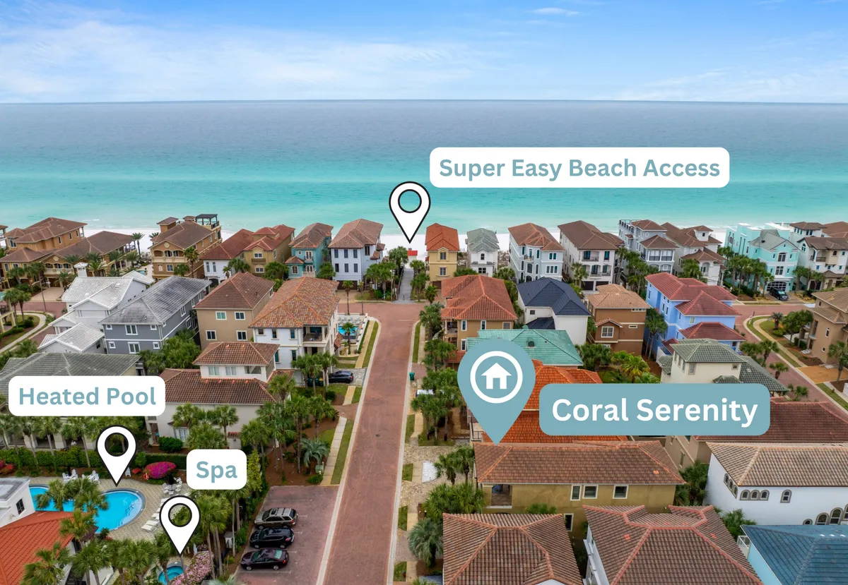 This exterior image shows the Coral Serenity property with its distinctive red-tiled roof, a private beach access path leading directly toward the ocean, and a heated pool area with an adjacent spa. The landscaped grounds and spacious community setting are visible, adding to the sense of tranquility and security.